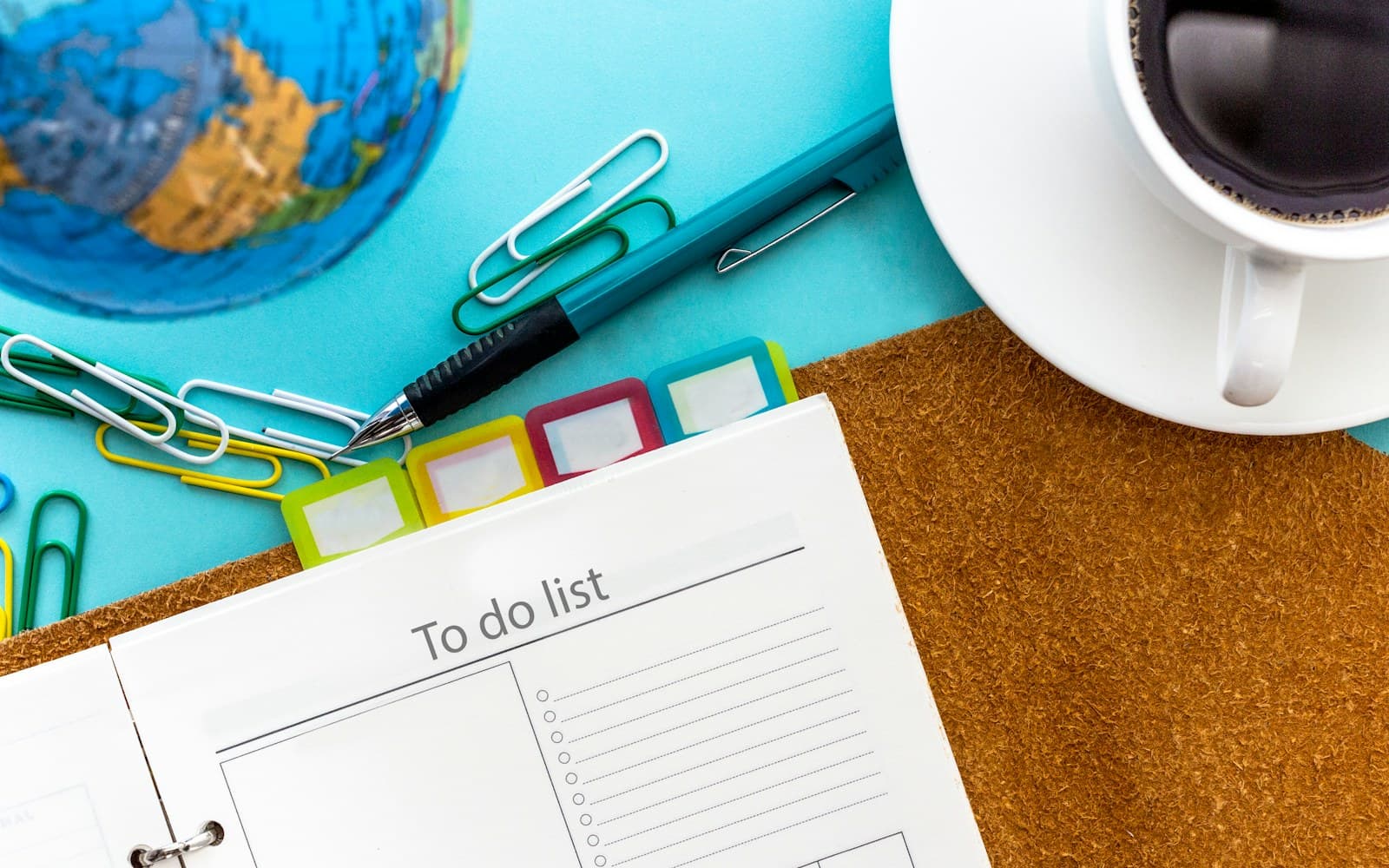 An open planner and to-do list on a desk