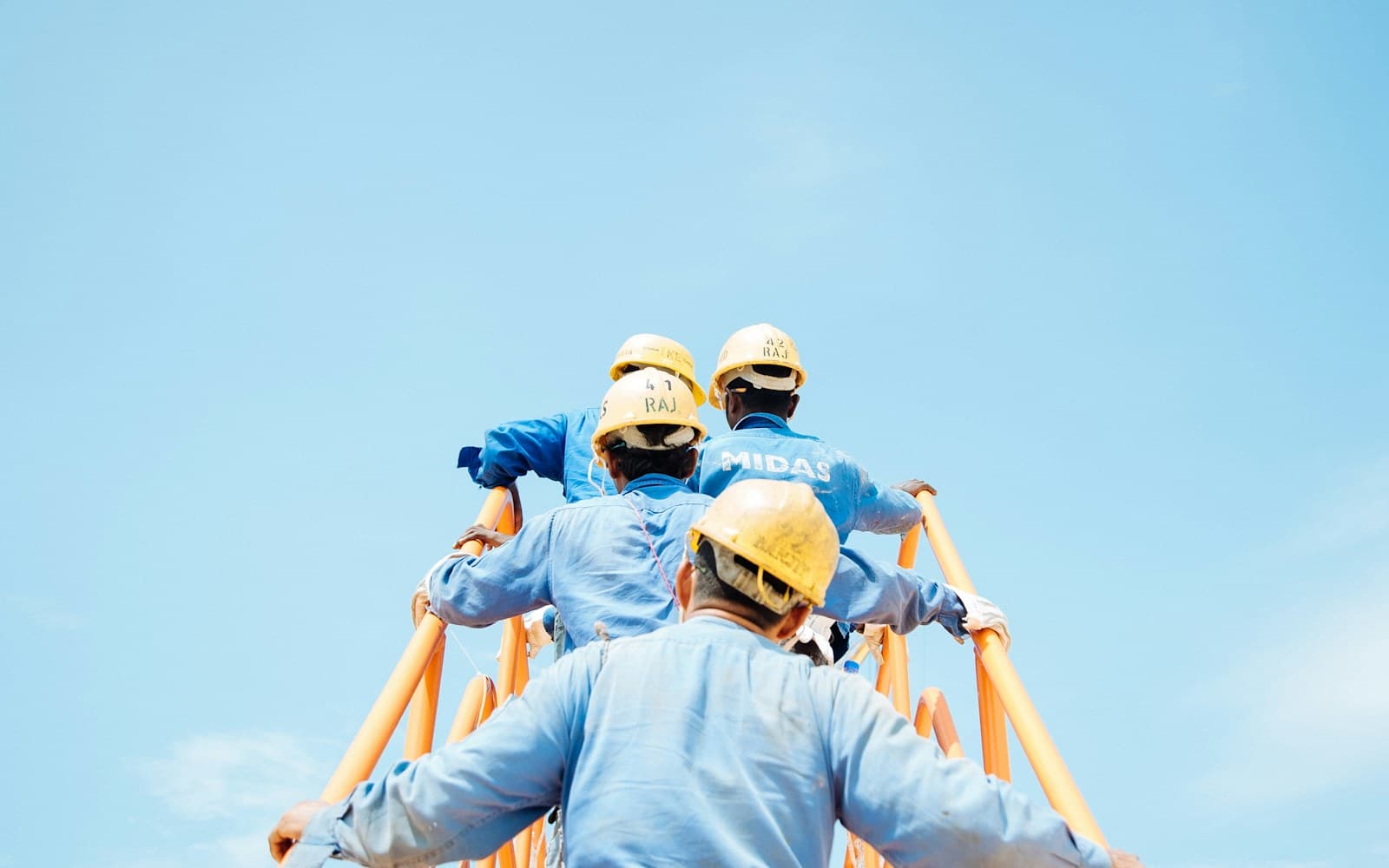 Industrial workers wearing protective clothing and hard hats
