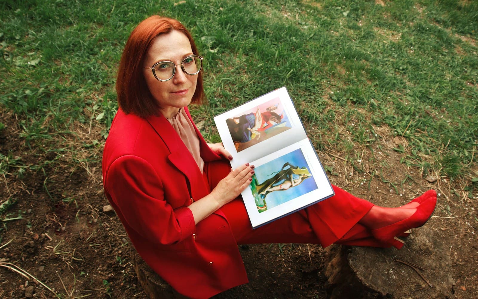 A confident woman in her mid-50s seated outdoors